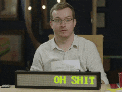 a gif of griffin mcelroy in front of a moving sign that reads "oh shit this thing has other colors"